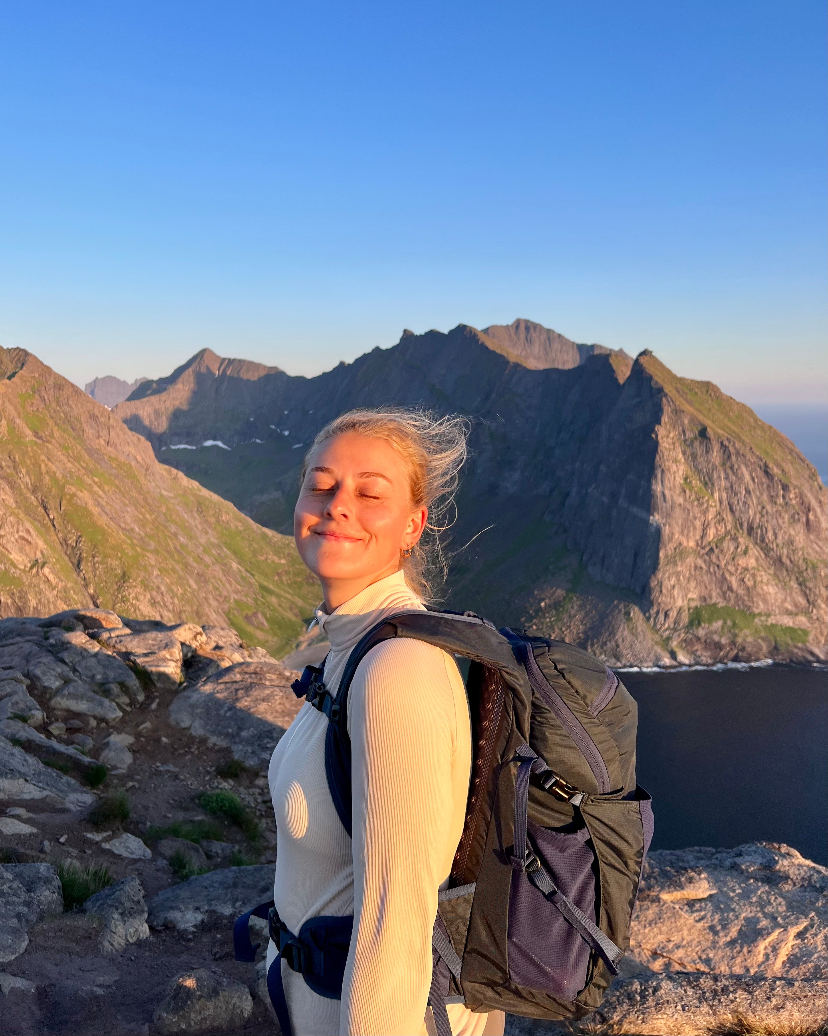 Rachel smiling at the top of a mountain in Norway